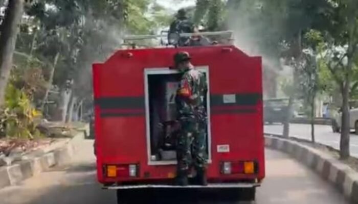 Koramil Sukmajaya Semprot Jalan Cegah Abu Vulkanik Anak Krakatau Beterbangan